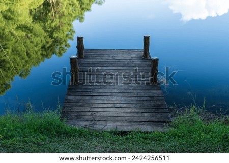 wooden pier on blue lake background