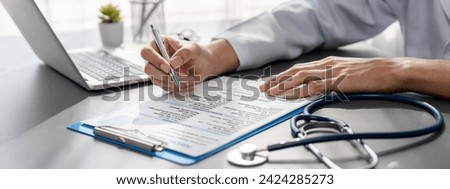 Doctor carefully review detailed medical report with laptop and diagnosing illness for effective healthcare treatment plan for patient in doctor office. Professional medical evaluation. Neoteric Royalty-Free Stock Photo #2424285273