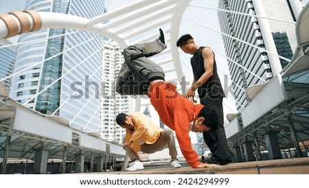 Group of professional happy street dancer cheer up while asian hipster perform b boy dance at urban city surrounded by people with low angle camera. Break dance concept. Outdoor sport 2024. Sprightly. Royalty-Free Stock Photo #2424294999