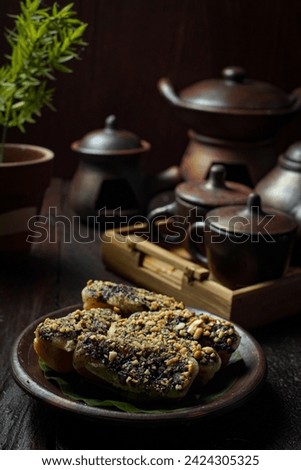 Pukis cake with peanut crumb topping and chocolate sprinkles on a clay plate. Pukis cake dessert is a traditional Indonesian cake or snack made from flour-based dough. Close up picture of pukis cake