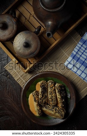 Pukis cake with peanut crumb topping and chocolate sprinkles on a clay plate. Pukis cake dessert is a traditional Indonesian cake or snack made from flour-based dough. Close up picture of pukis cake