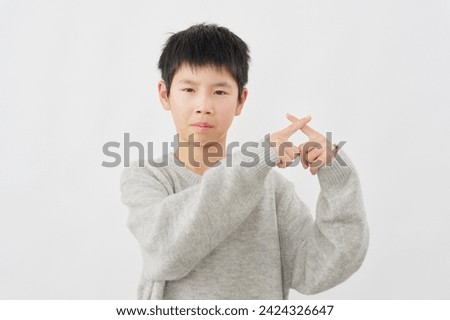 Asian boy  x sign gesture by hand in white background