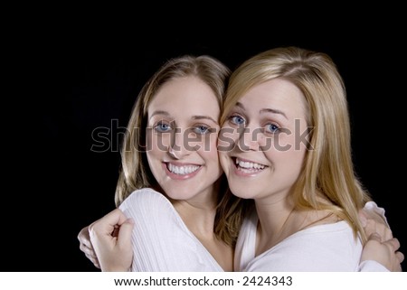 Beautiful Blond sisters hugging