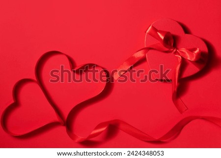 Valentine day composition with gift box and red hearts, photo template on deep red background.