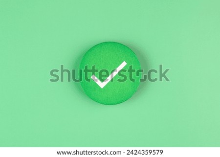 Tick mark on a green background.