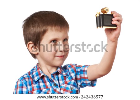 Little boy photographing himself makes selfie isolated
