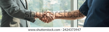Long exposure of handshake of two business partners or agent and client congratulating one another on new signed contract