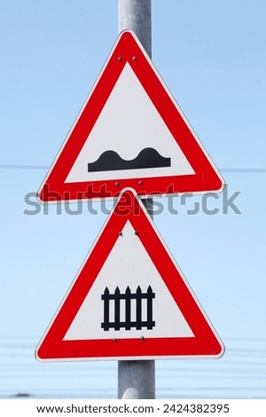 Danger sign, traffic sign for gated level crossing, uneven roadway, Germany
