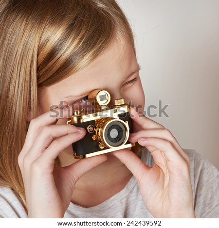 Girl photographer takes a picture retro camera