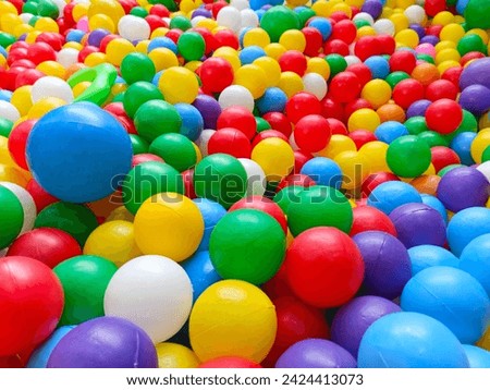 This lively image captures colorful balls scattered in a vibrant ball pit arena, evoking excitement and joy part 3