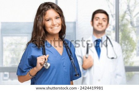 Portrait of happy female and male medical professionals in a bright clinic setting