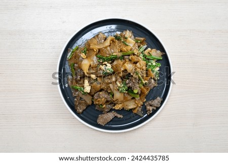 A plate of beef pad see ew. Royalty-Free Stock Photo #2424435785