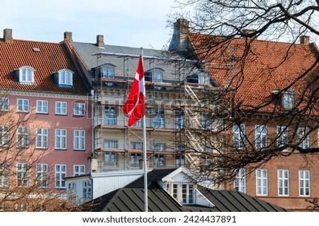 Waving flag of Denmark on a city street