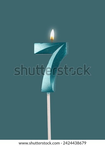 7 birthday, number candles with light, isolated on white background