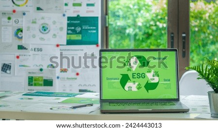 ESG ( environment, social,governance) recycle sign on laptop screen with carbon free chart board in office