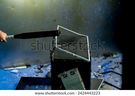 warehouse of broken discarded computer monitors and televisions broken equipment disposal hit with baseball bat