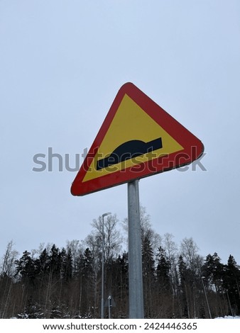 Speed obstacle traffic sign . Forest and sky in the background.