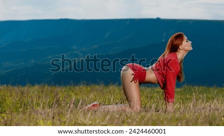 Young attractive fit woman having fitness workout training on mountain landscape, Active summer morning: girl's workout amidst mountainous natural scenery