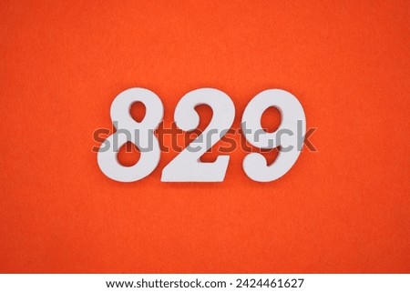 Orange felt is the background. The numbers 829 are made from white painted wood.