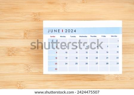 June 2024 calendar page on wooden background with empty space. Royalty-Free Stock Photo #2424475507