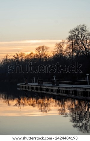 calm dock reflection in sunset light.
