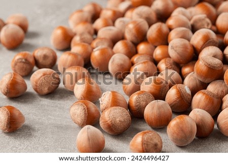 A large group of shelled hazelnuts on the table. Low angle view. Royalty-Free Stock Photo #2424496427