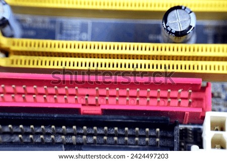 A closeup of a computer main board electronic motherboard, the main printed circuit board (PCB) in general-purpose computers and other expandable systems, allows communication of electronic components Royalty-Free Stock Photo #2424497203