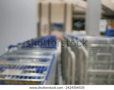 Blur focus of shoping cart line up in front of the shop