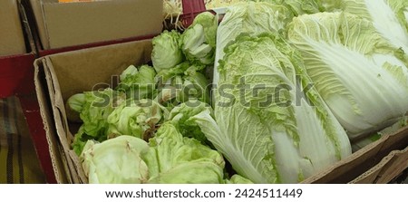 This is a picture of lettuce next to fruit