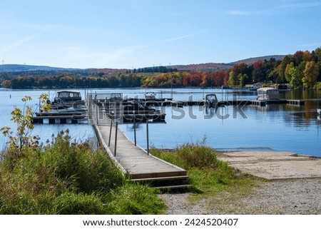 An empty marina in the Quebec fall colors Royalty-Free Stock Photo #2424520407