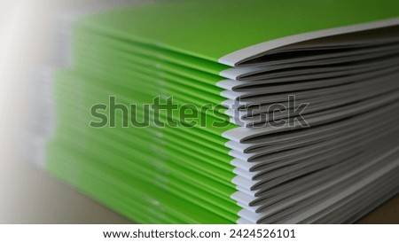Stitched printing brochures in the bookbindery or print shop. Print sorted with spine. Lettershop or bookbinder. Royalty-Free Stock Photo #2424526101