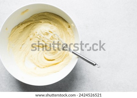 Top view of Creaming butter and sugar with a whisk, the process of making a cake, overhead view of mixing butter and sugar to make a pound cake Royalty-Free Stock Photo #2424526521