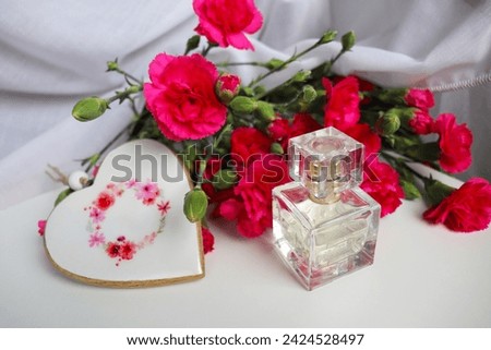 romantic composition of a bouquet of flowers and a bottle of perfume