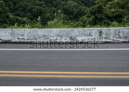 Side view of asphalt road with forests background.