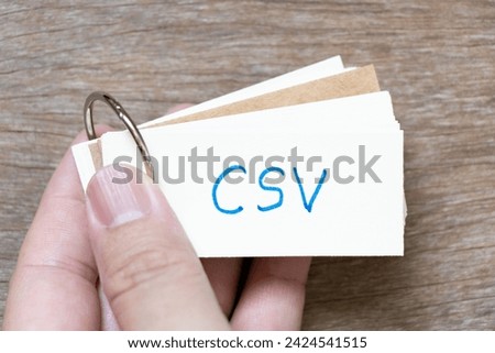 Hand hold flash card with handwriting in word on wood background