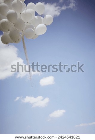 White balloons on blue sky background stock photo
