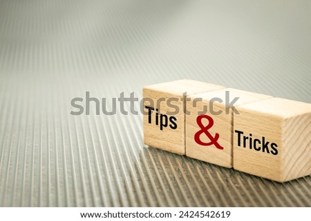 Tips and tricks symbol, Business words written on wooden blocks, Tips and tricks concept. Copy space. Beautiful fluted glass background, copy space