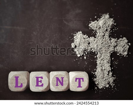 Lent Season, Holy Week, Ash Wednesday concepts. Word LENT on wooden cubes with ash cross symbol in dark background. Stock photo.