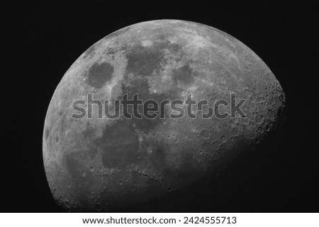 Shot of the half moon in a clear spring night .black and white photo          