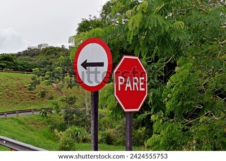 Traffic sign indicating one way adn STOP (pare) in Ribeirao Preto, Sao Paulo, Brazil