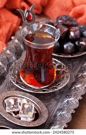 Tea  in glass cups and Turkish Delight on copper tray on  wooden background