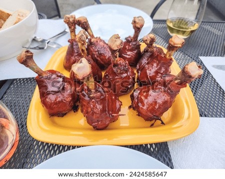 Chicken lollipop is a popular Indian fried chicken appetiser. Chicken lollipop is chicken winglet, wherein the meat is cut loose from the bone end and pushed down, creating a lollipop appearance. Royalty-Free Stock Photo #2424585647