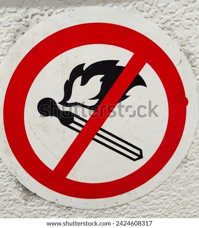 A sign prohibiting smoking in public places. An image of a crossed-out smoking cigarette in a red circle. The harm of smoking and tobacco. Air and environmental pollution. Ecology. Dependence. Royalty-Free Stock Photo #2424608317