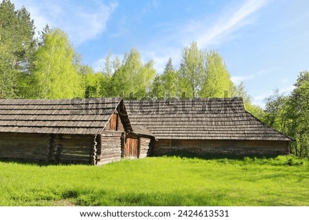 Traditional wooden Ukrainian houses from Transcarpathia in Pirogovo, Ukraine Royalty-Free Stock Photo #2424613531
