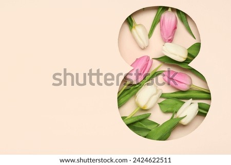 Cut paper in shape of figure 8 with beautiful tulips on beige background. International Women's Day