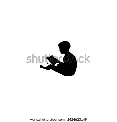 The little boy is reading a book. People enjoy summer. Little boy reading book sitting on the beach, tourist, island, travel, palm tree, rest. Silhouette little boy sitting on the beach