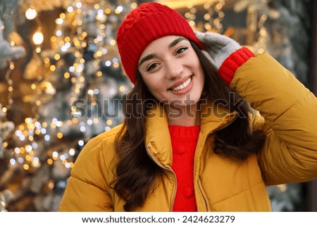 Portrait of smiling woman on blurred background. Winter time