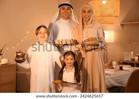 Happy Muslim family with traditional food at home in evening. Ramadan celebration