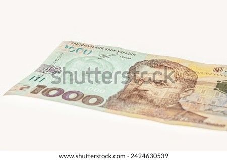 1000 Ukrainian Hryvnia banknote on white background. 1000 uah watermark. Fragment of Ukrainian banknotes. New banknote denomination of 1000 UAH. 1000 Hryven Banknote closeup