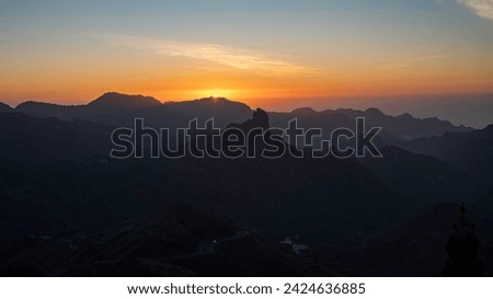 Sunset with the silhouette of Roque Bentayga and Roque Nublo on the island of Gran Canaria Royalty-Free Stock Photo #2424636885